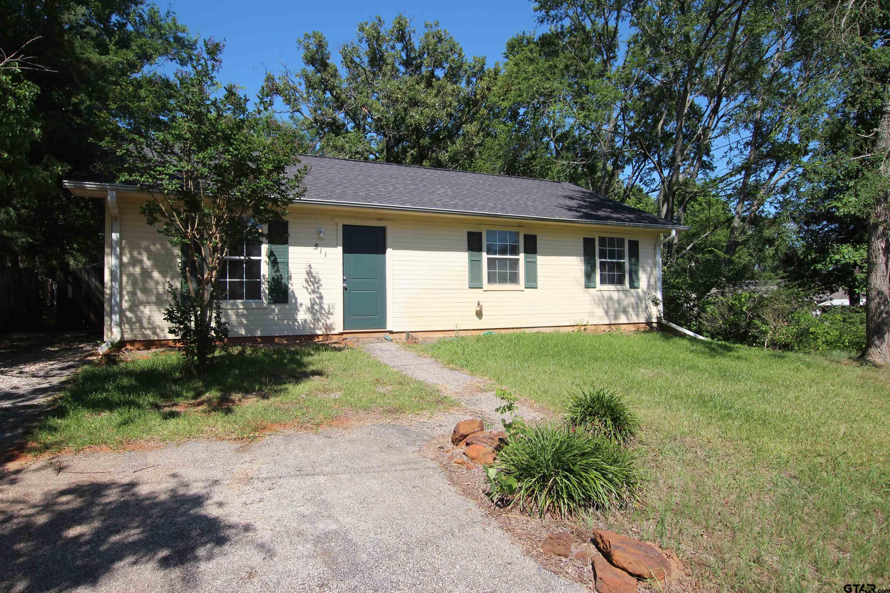 a front view of house with yard and green space