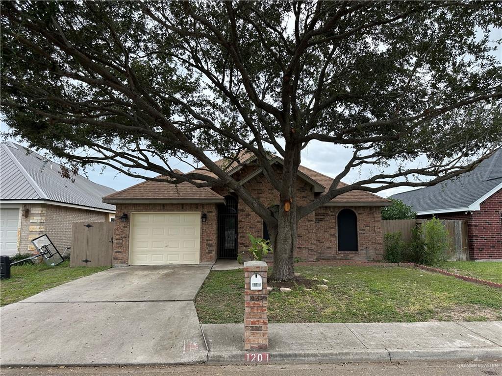 Single story home featuring a front lawn and a garage