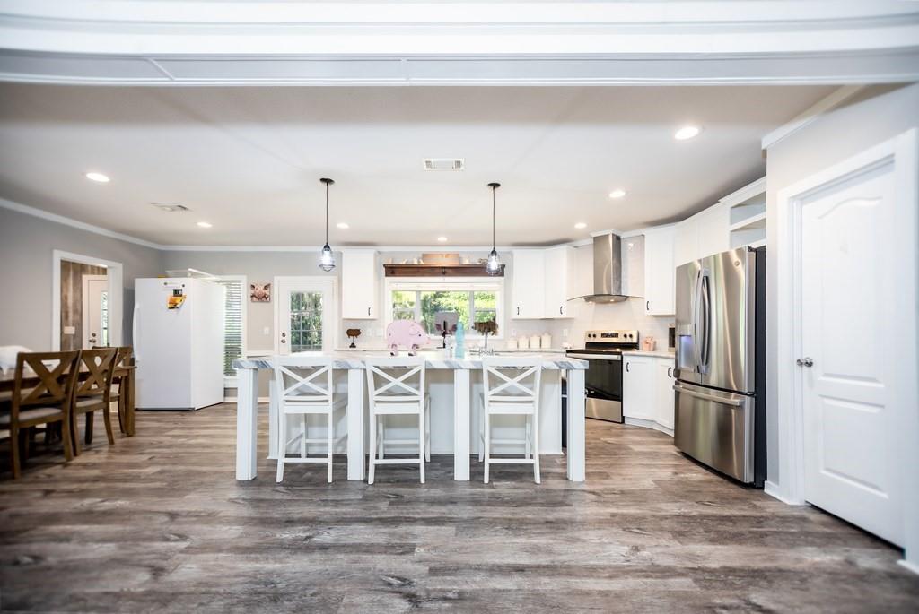 a large kitchen with a table and chairs