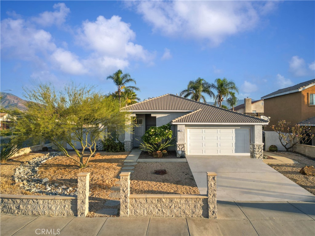 a view of a house with yard and sitting area