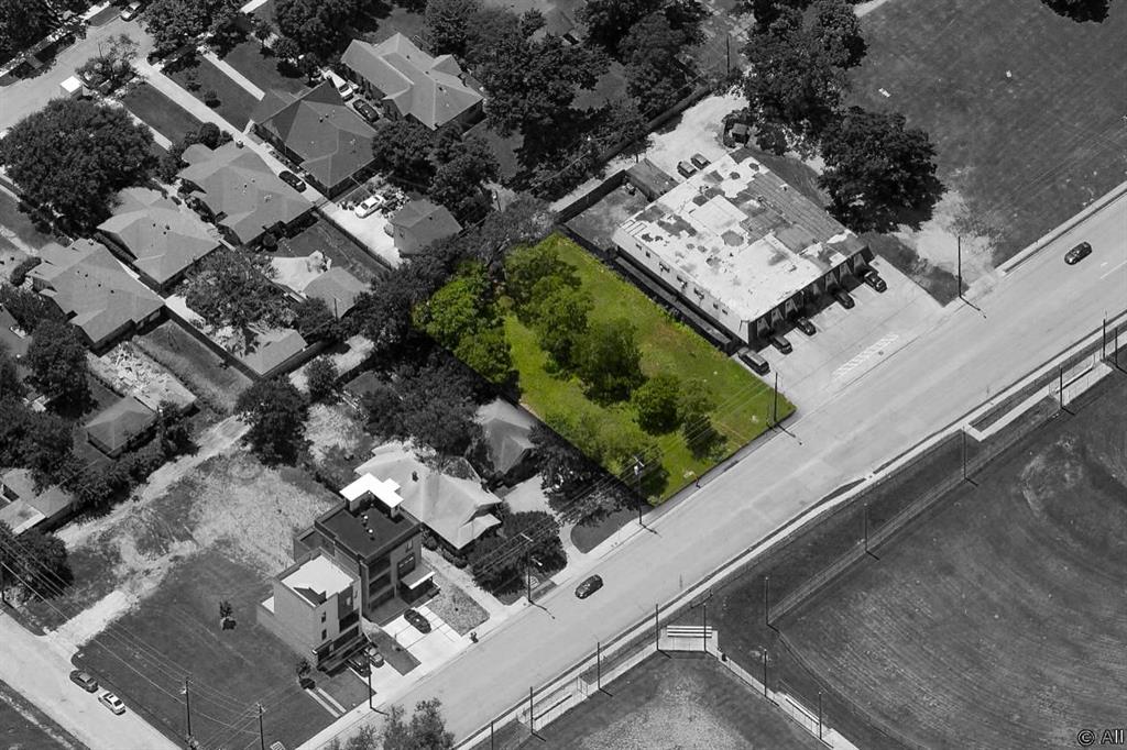 an aerial view of multiple houses with a yard