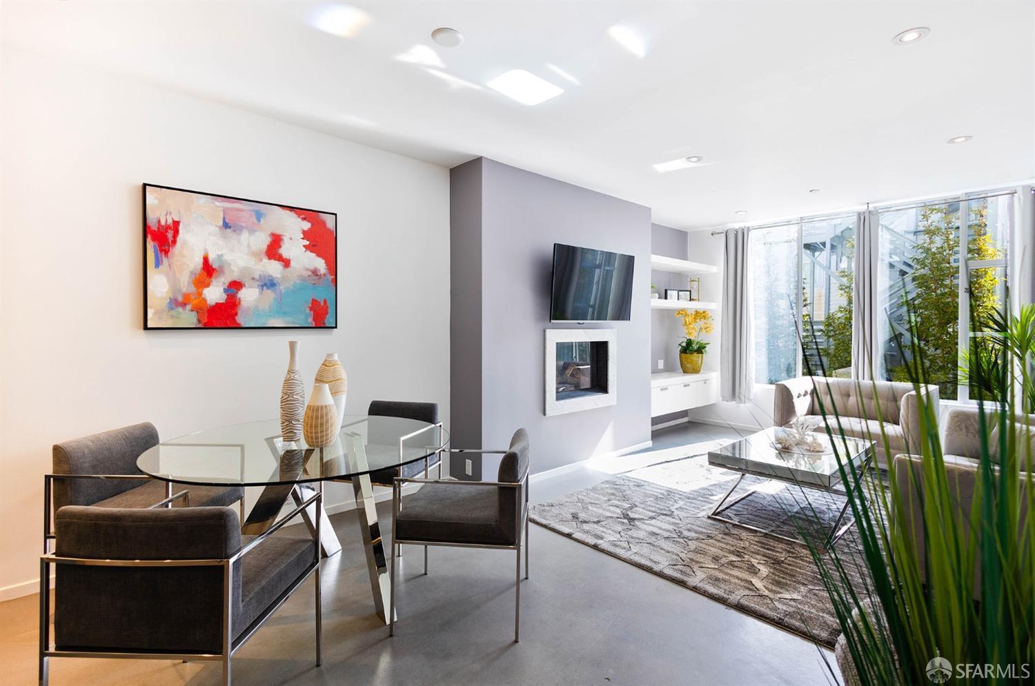 a living room with furniture a flat screen tv and a large window