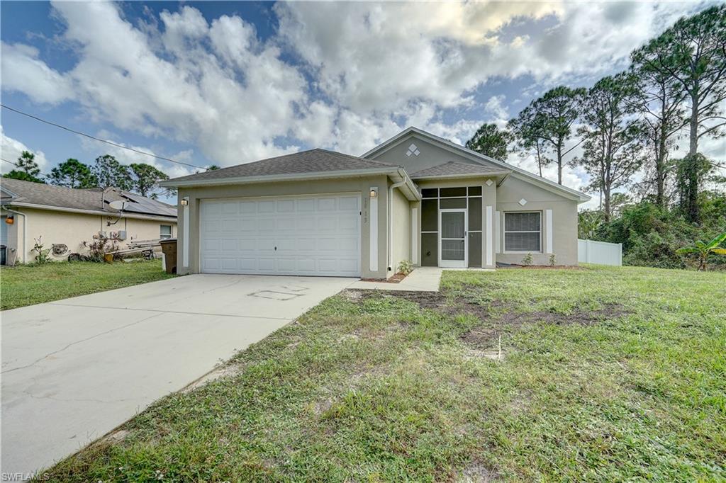 a front view of a house with a yard and garage