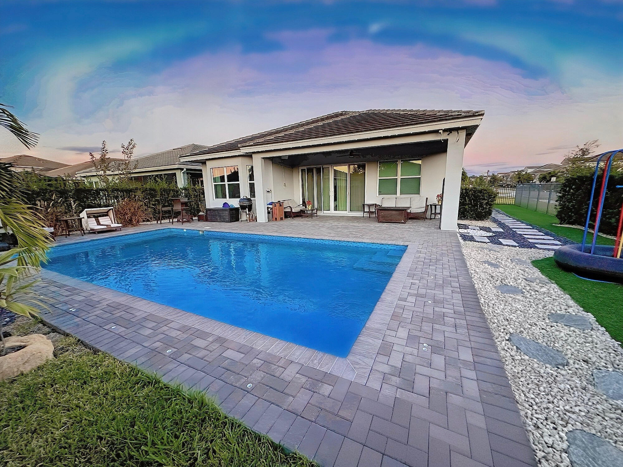 a view of house with swimming pool outdoor seating