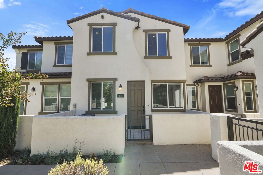 a front view of a house with a lot of windows