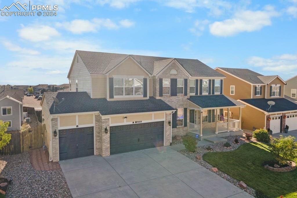 View of front of home featuring a porch and a garage