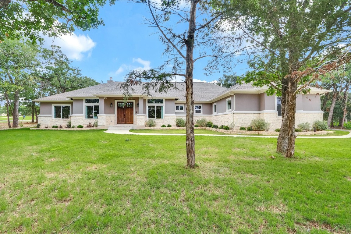 a view of a house with a backyard