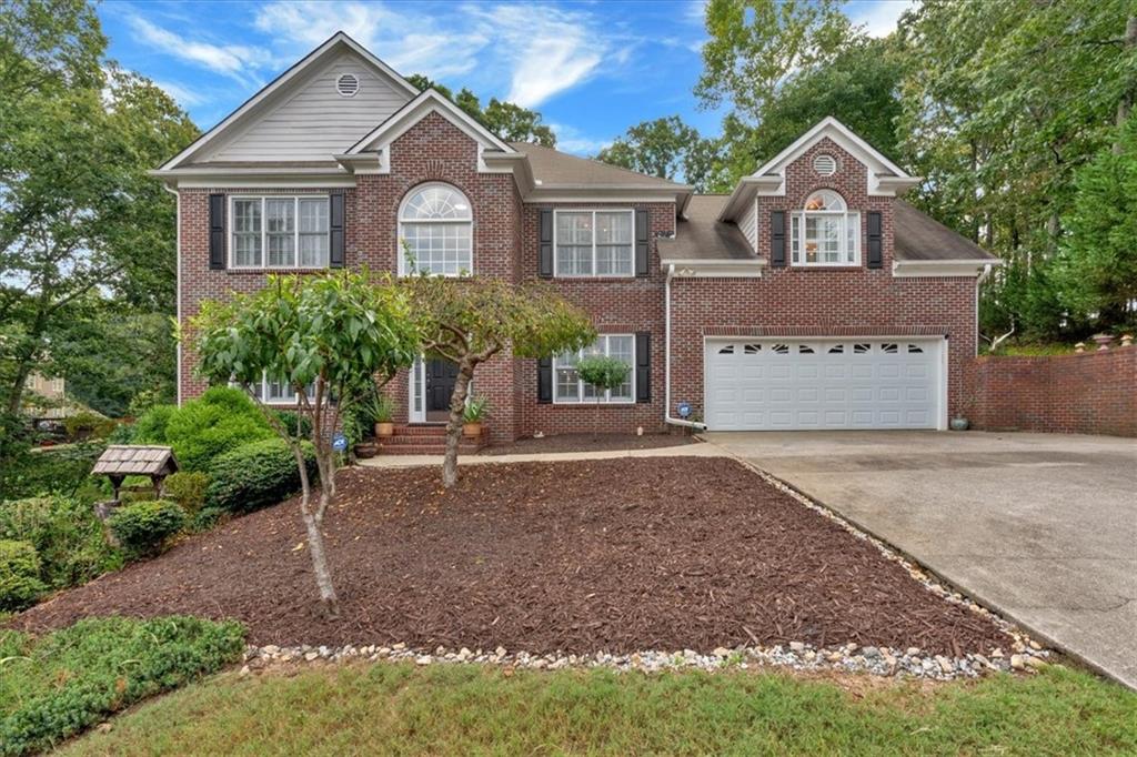 a front view of a house with a yard and garage