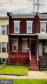 a view of a house with a small yard and a large window