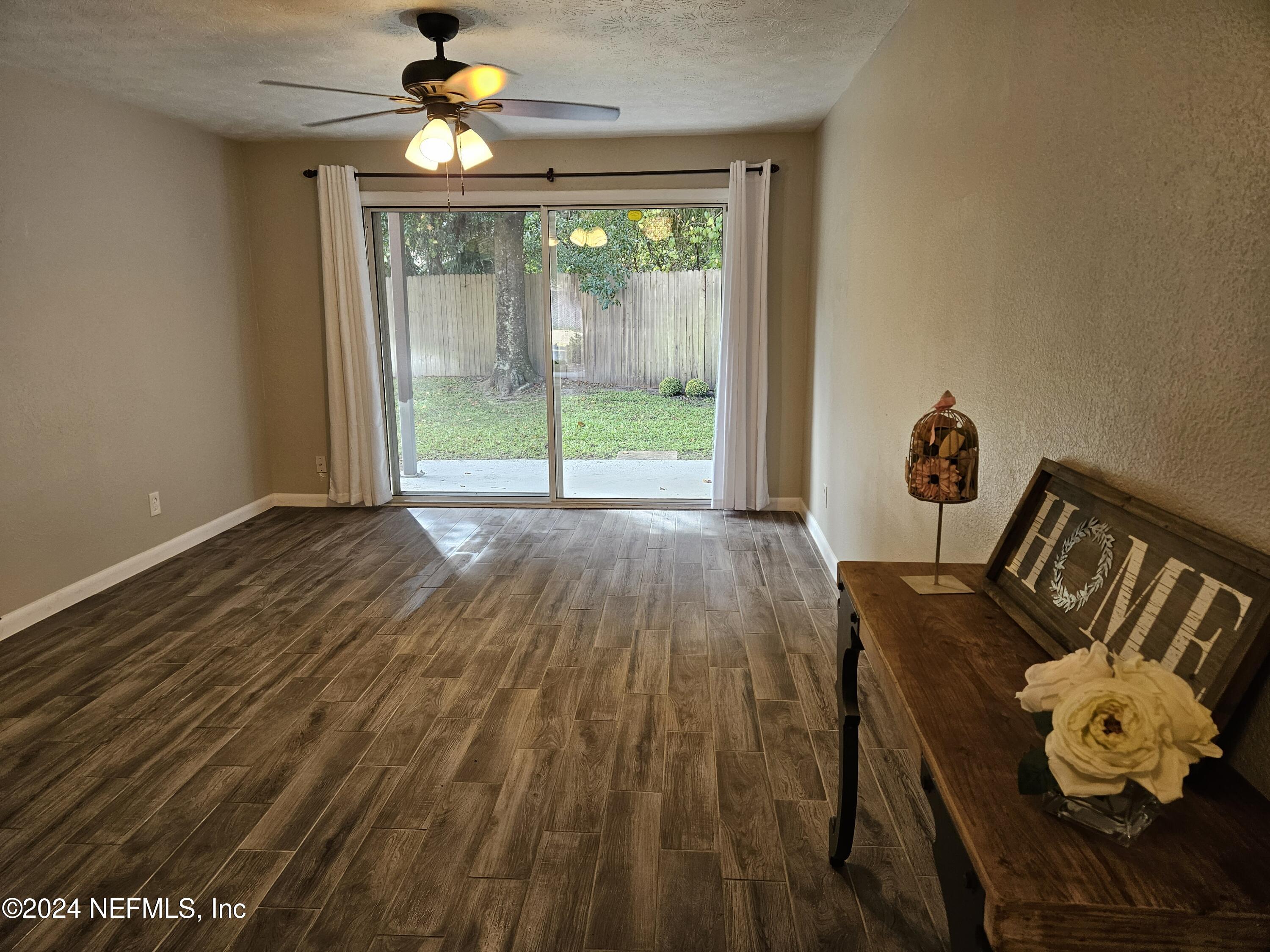 a view of a livingroom with furniture wooden floor chandelier