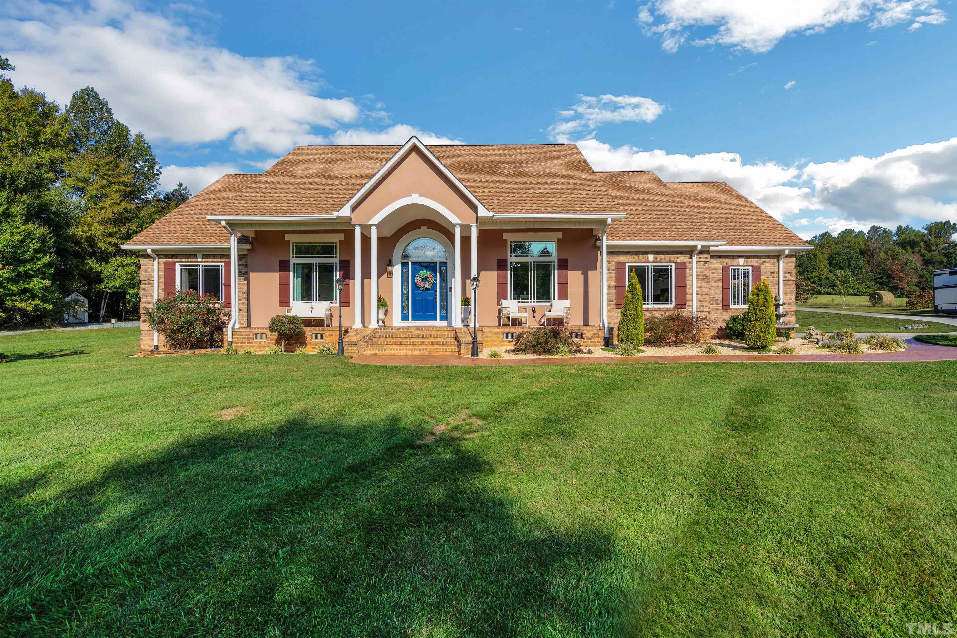 a front view of a house with a garden