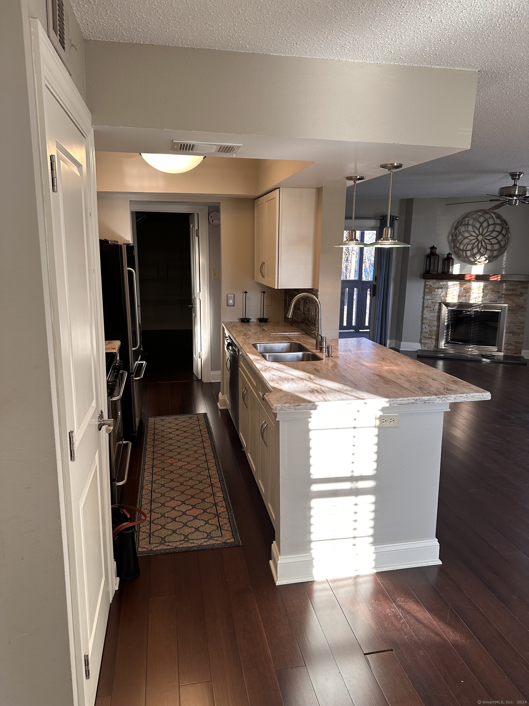 a kitchen view of a stove and wooden floor