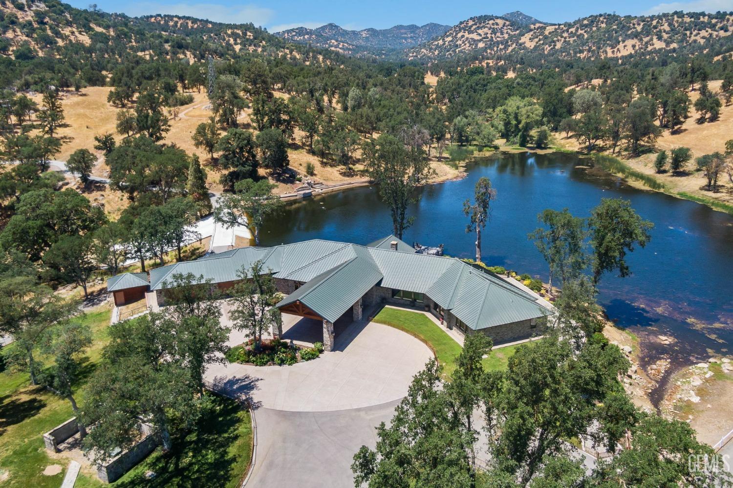 an aerial view of a house with a lake view