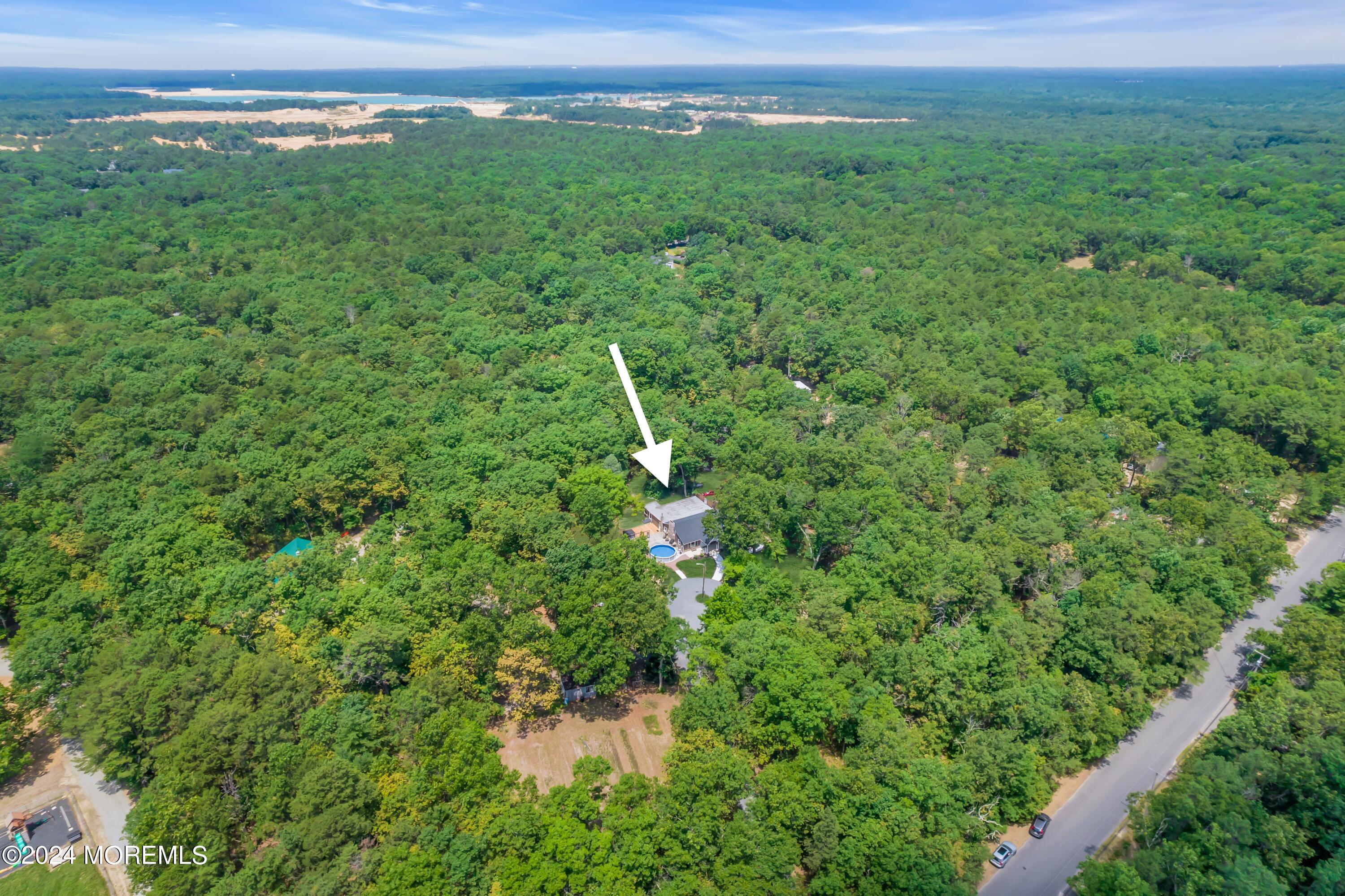 a view of a big yard with large trees