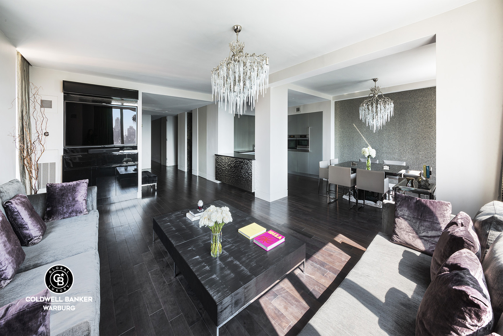 a living room with furniture and a chandelier