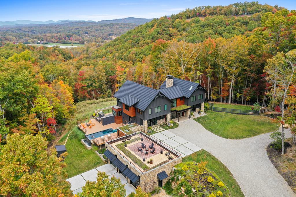 an aerial view of a house with garden space and trees