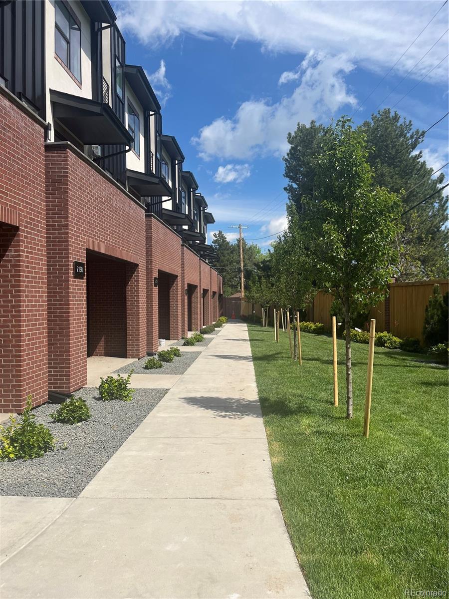 a pathway of a house with a yard