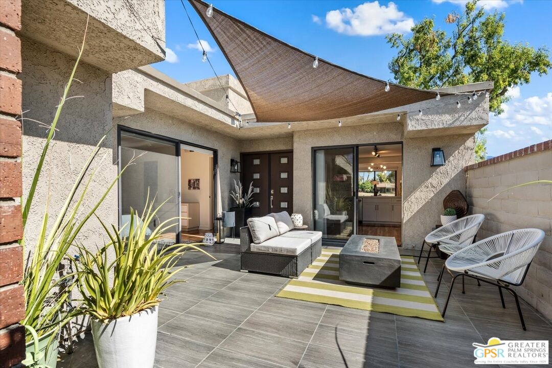 a building outdoor space with patio furniture and potted plants