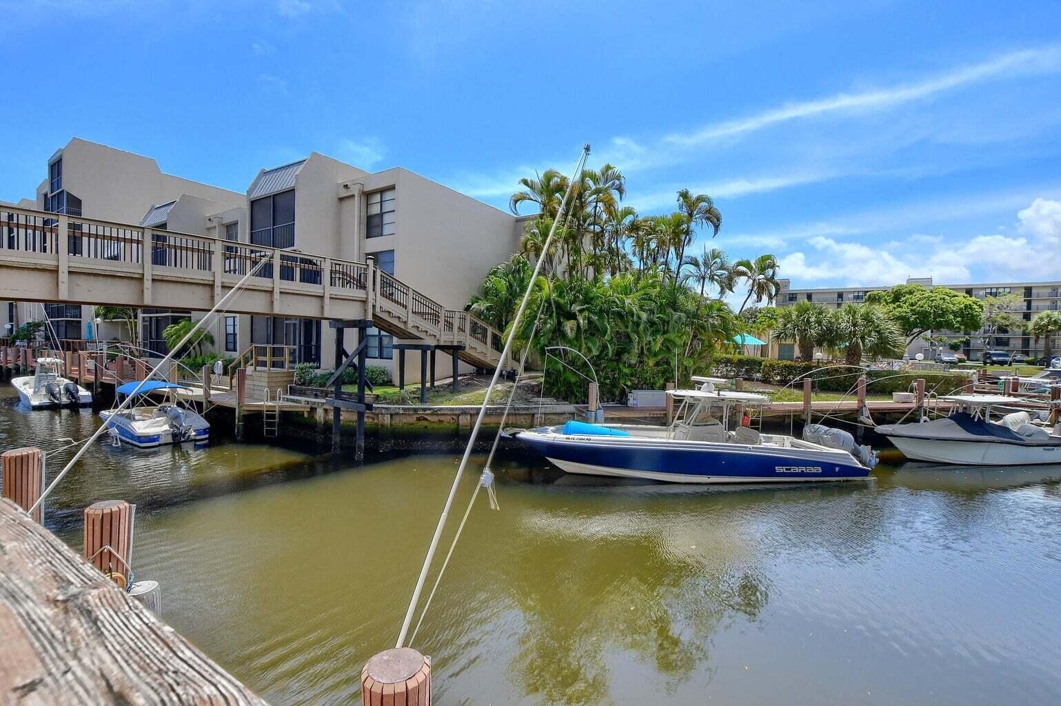 a view of an ocean with boats and palm trees