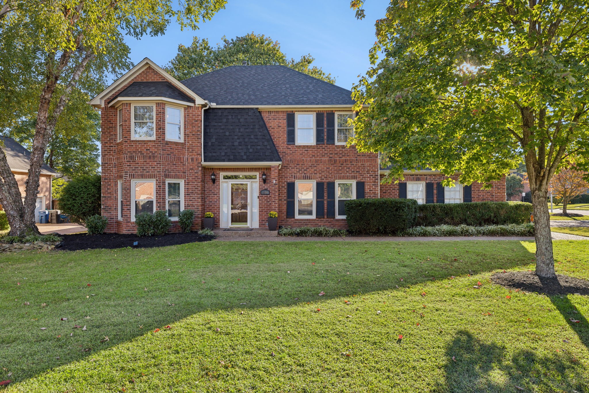 a front view of a house with a yard