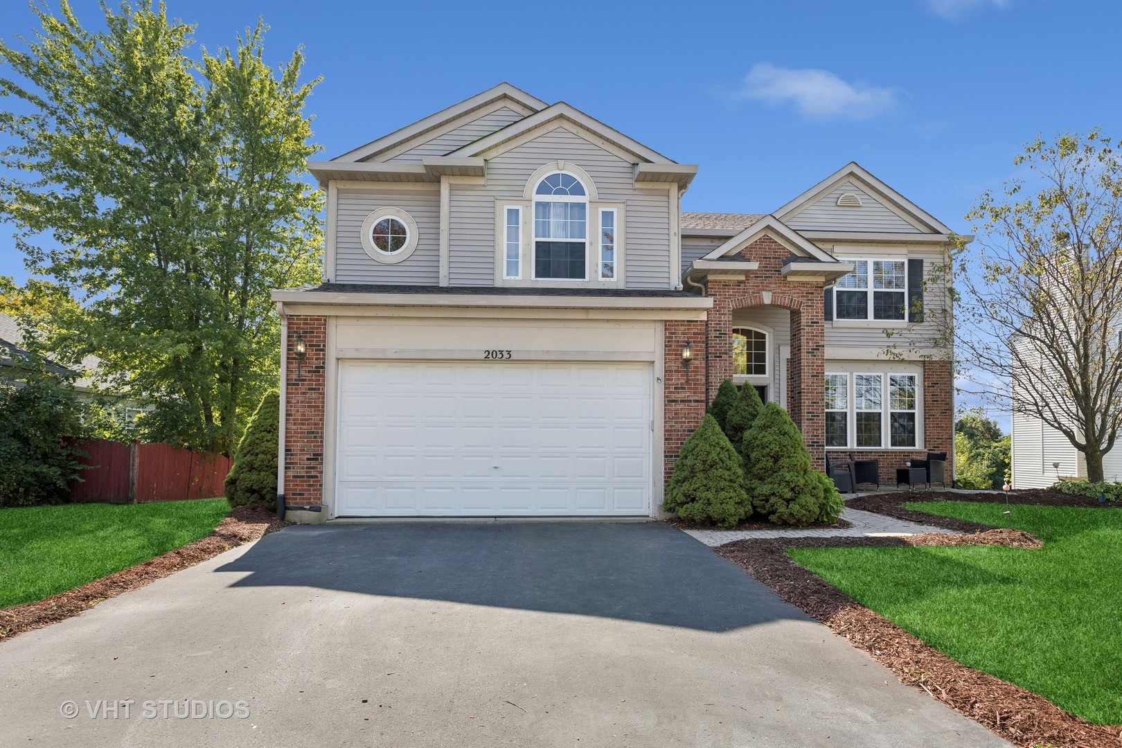 a front view of a house with a yard and garage