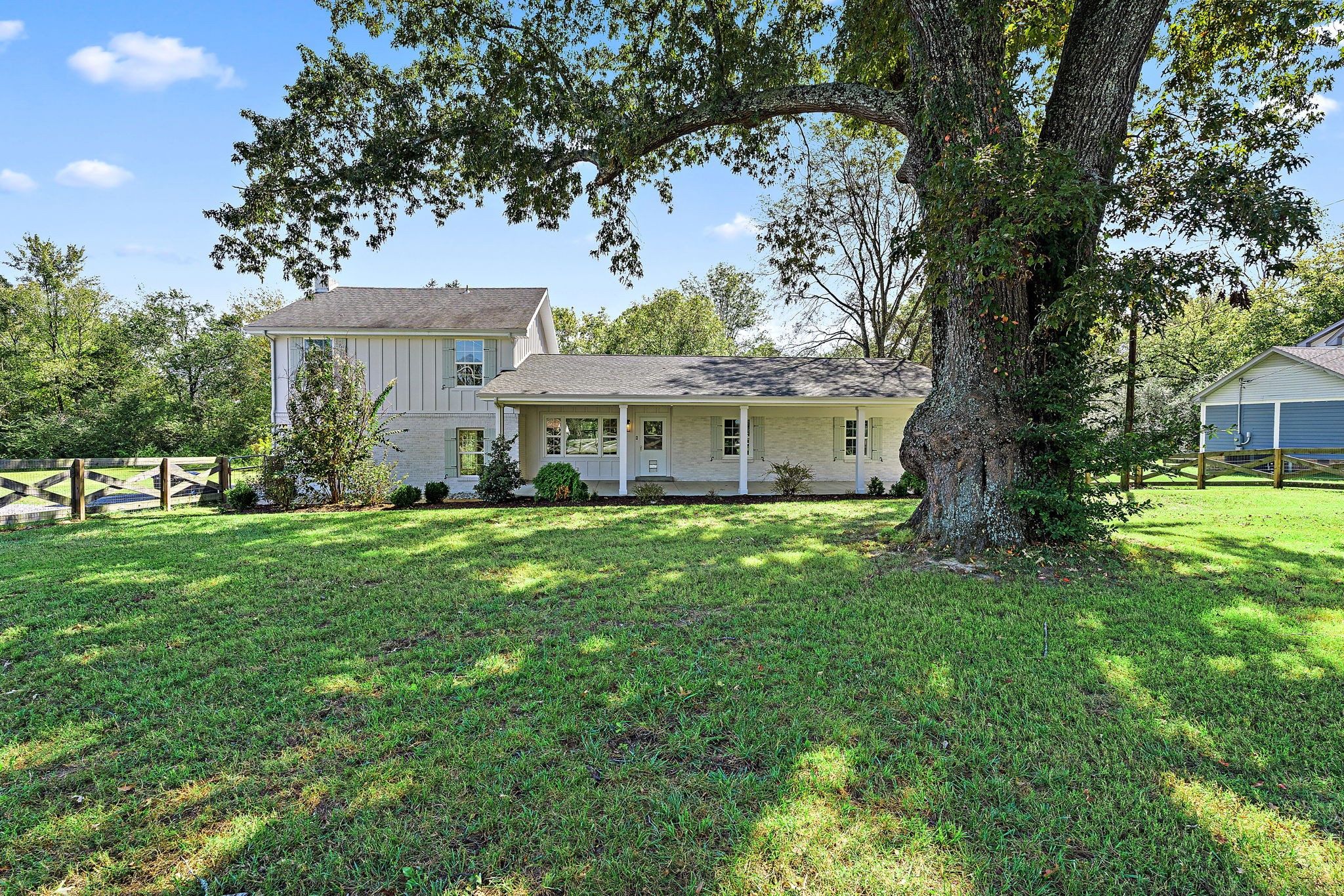 a front view of a house with a garden