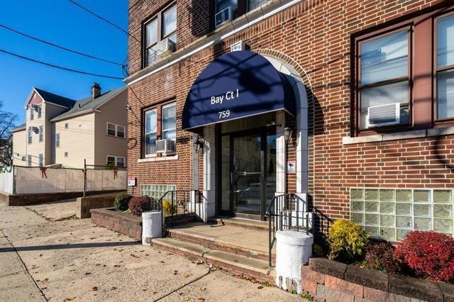 a front view of a building with potted plants