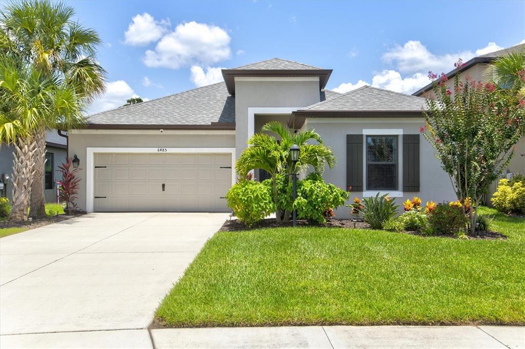 a front view of a house with a yard and garage