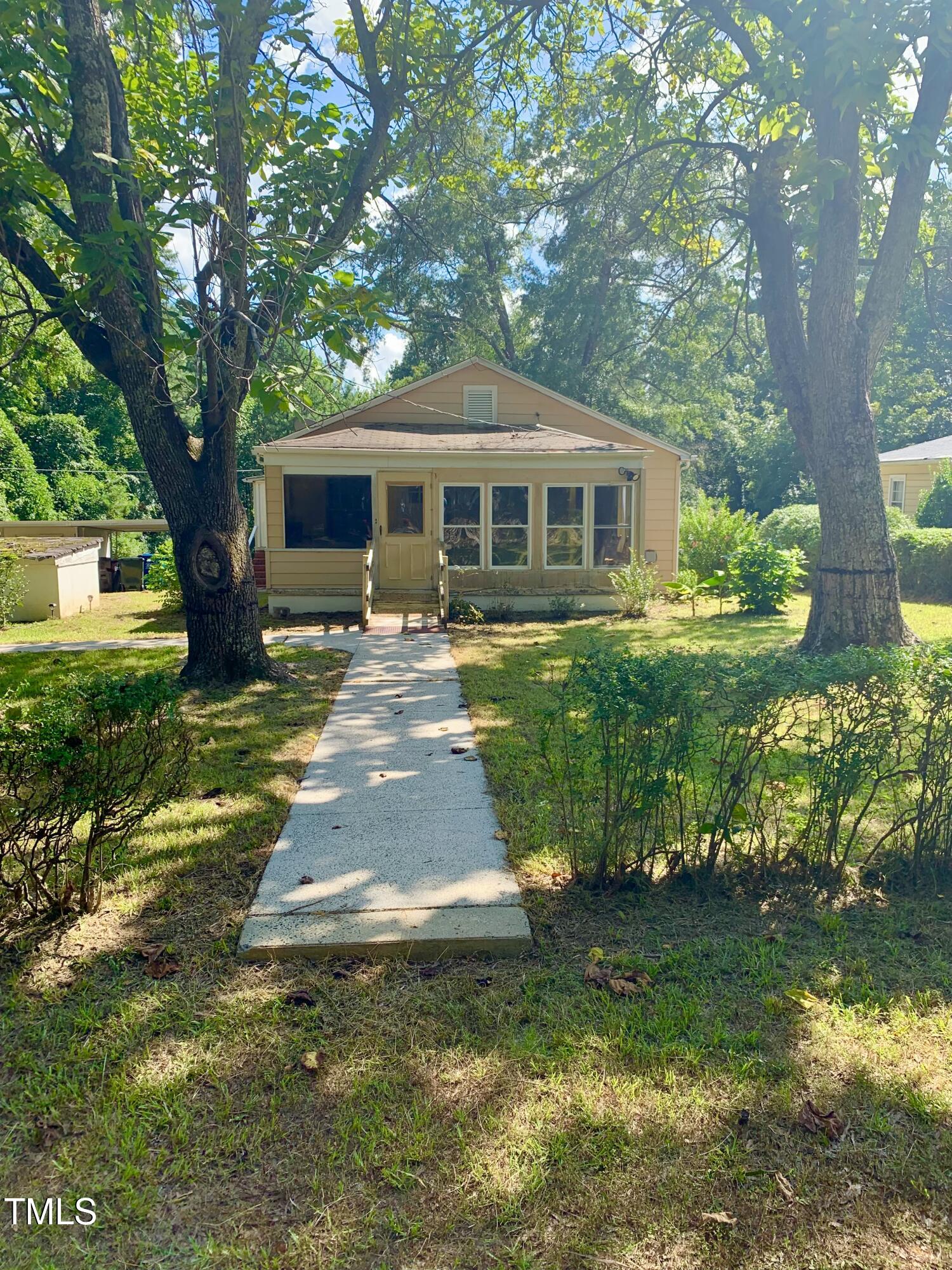 a front view of a house with yard and green space