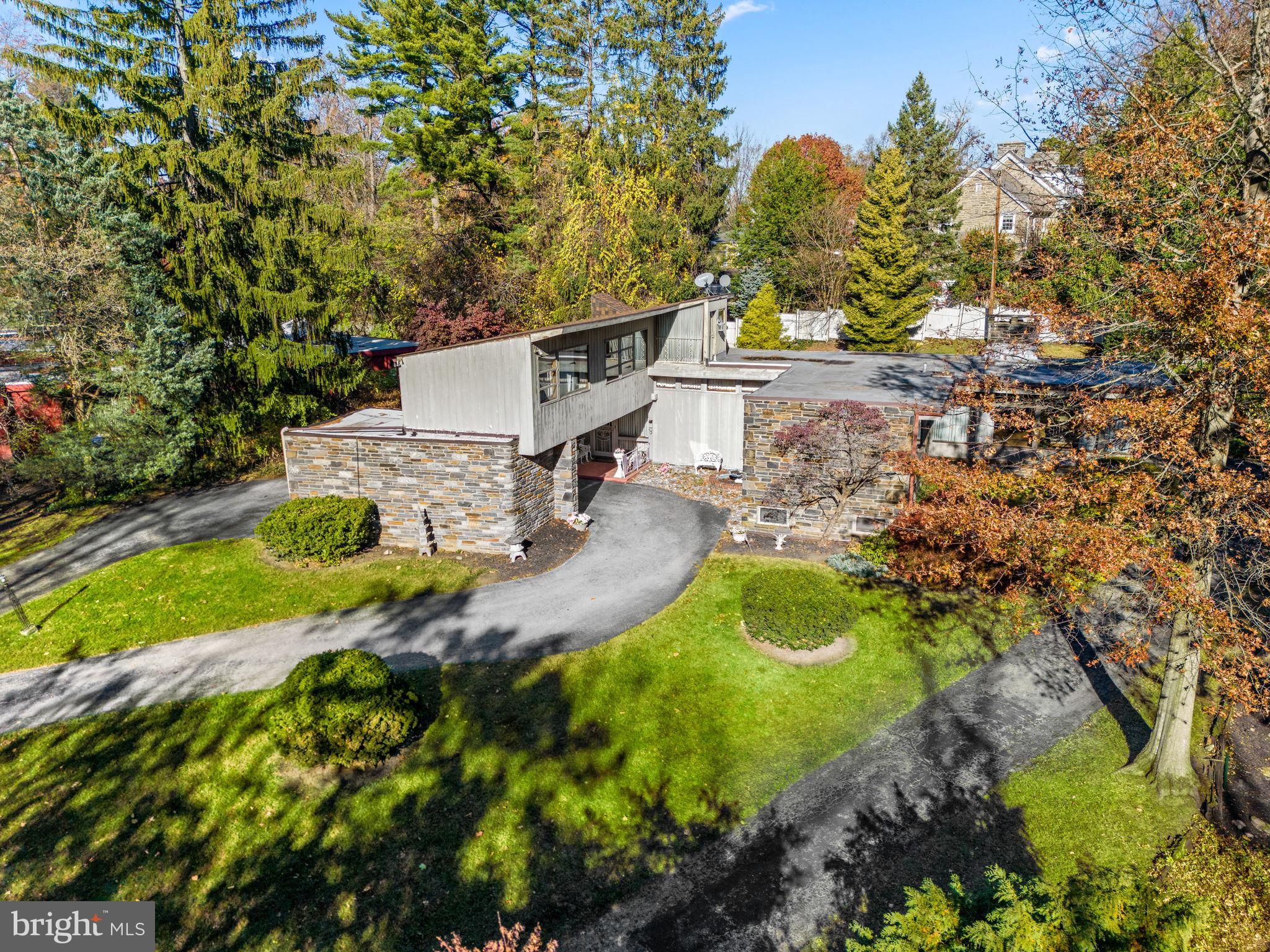 an aerial view of a house with yard swimming pool and outdoor seating