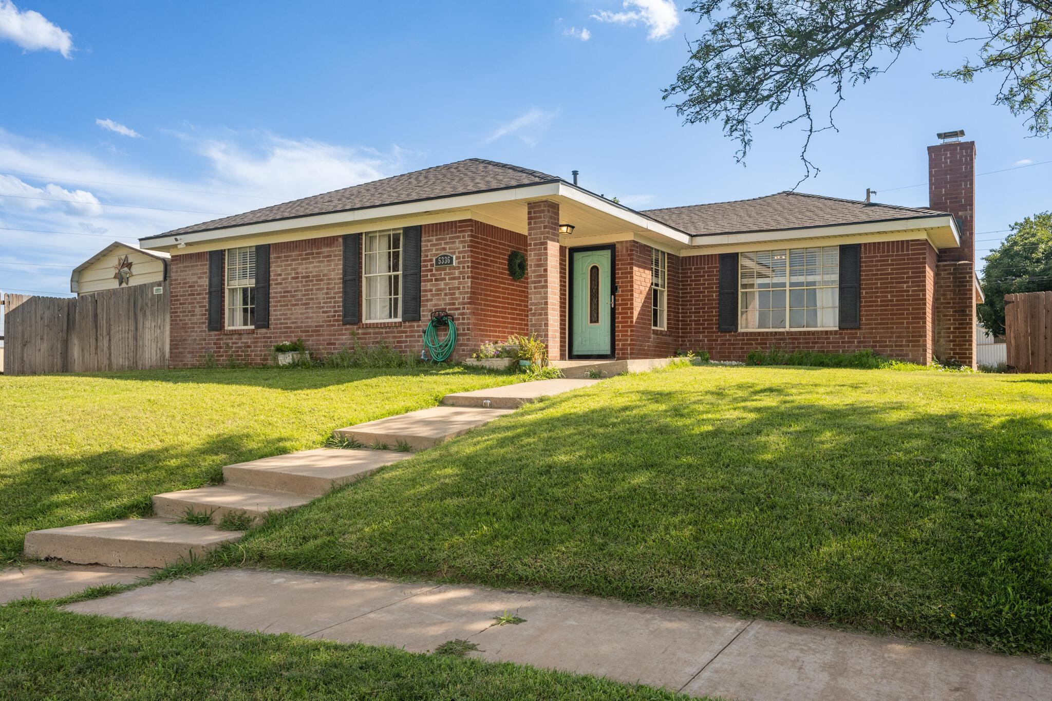 a front view of house with yard and swimming pool