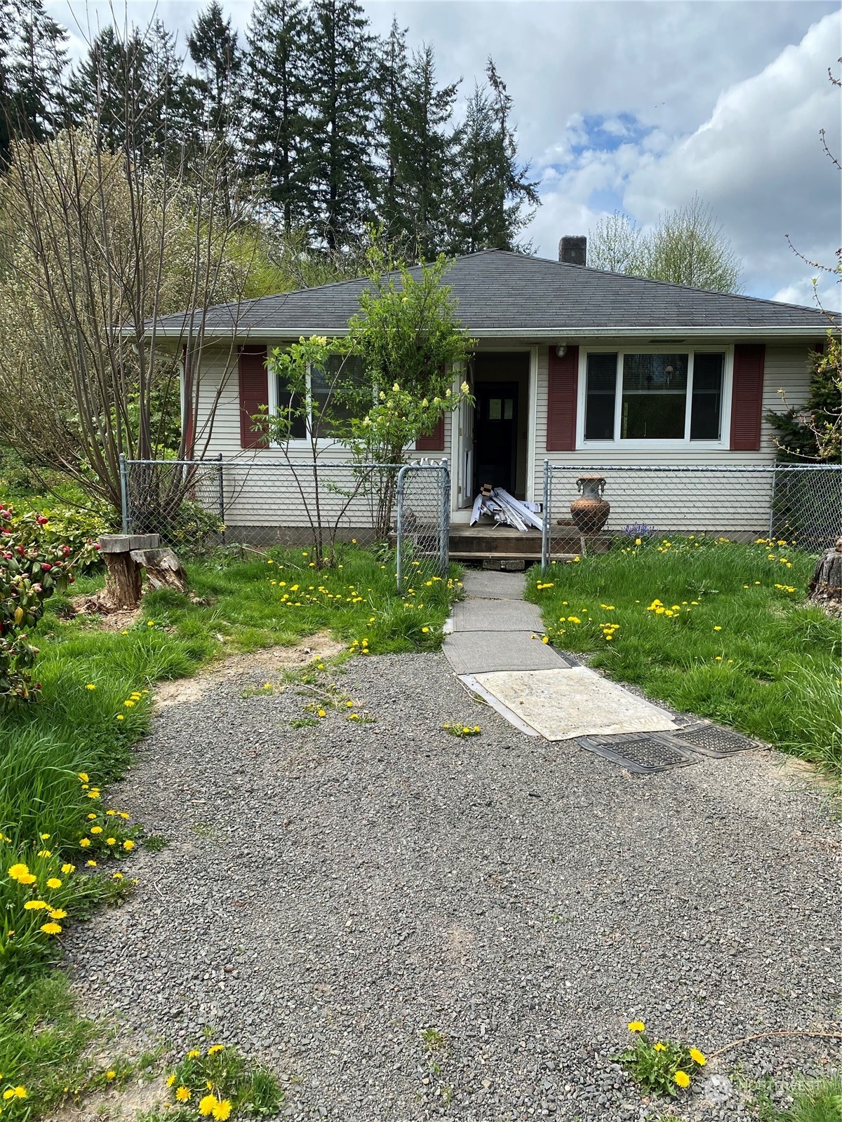 a front view of a house with garden and porch