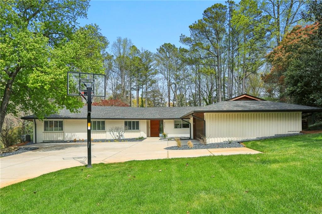 a view of a house with pool and a yard