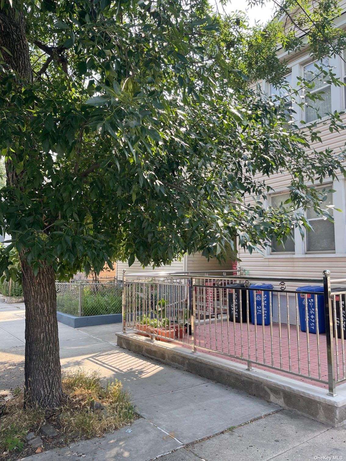 a view of house with backyard and a trees