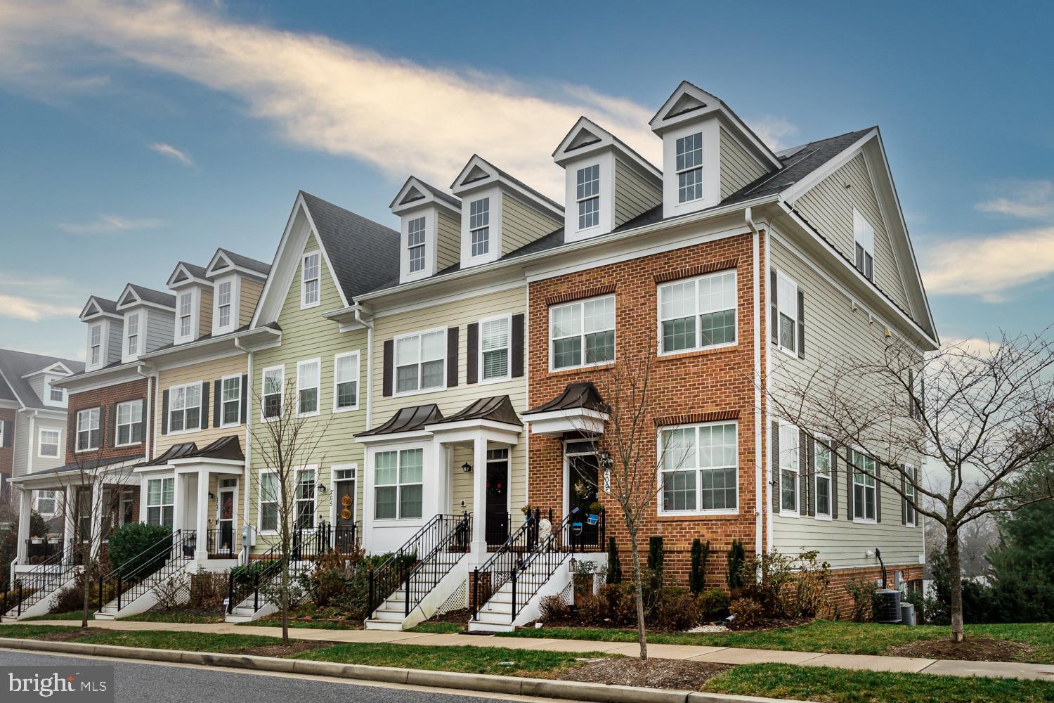 a front view of a residential apartment building with a yard