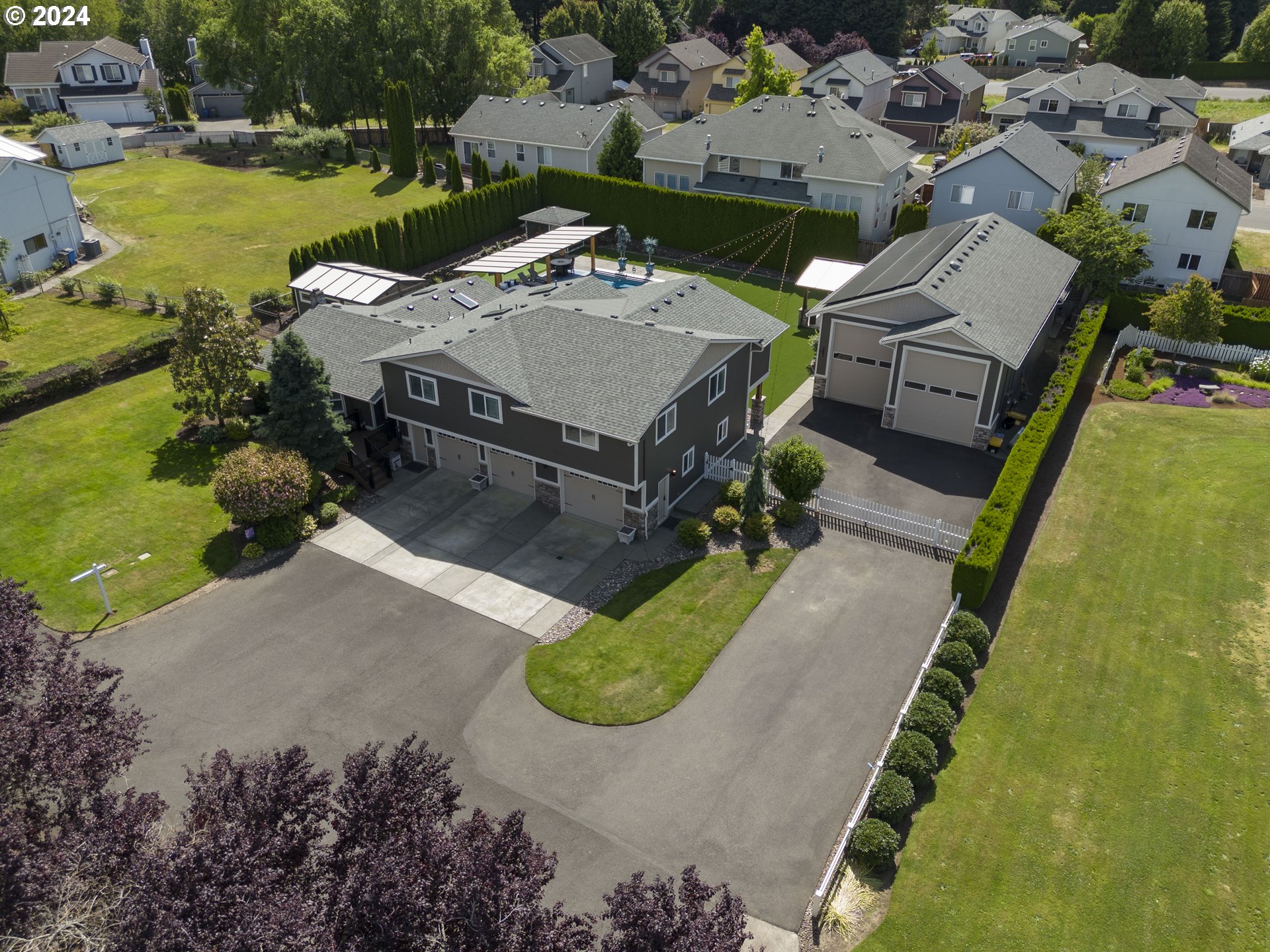 an aerial view of a house with yard swimming pool and outdoor seating