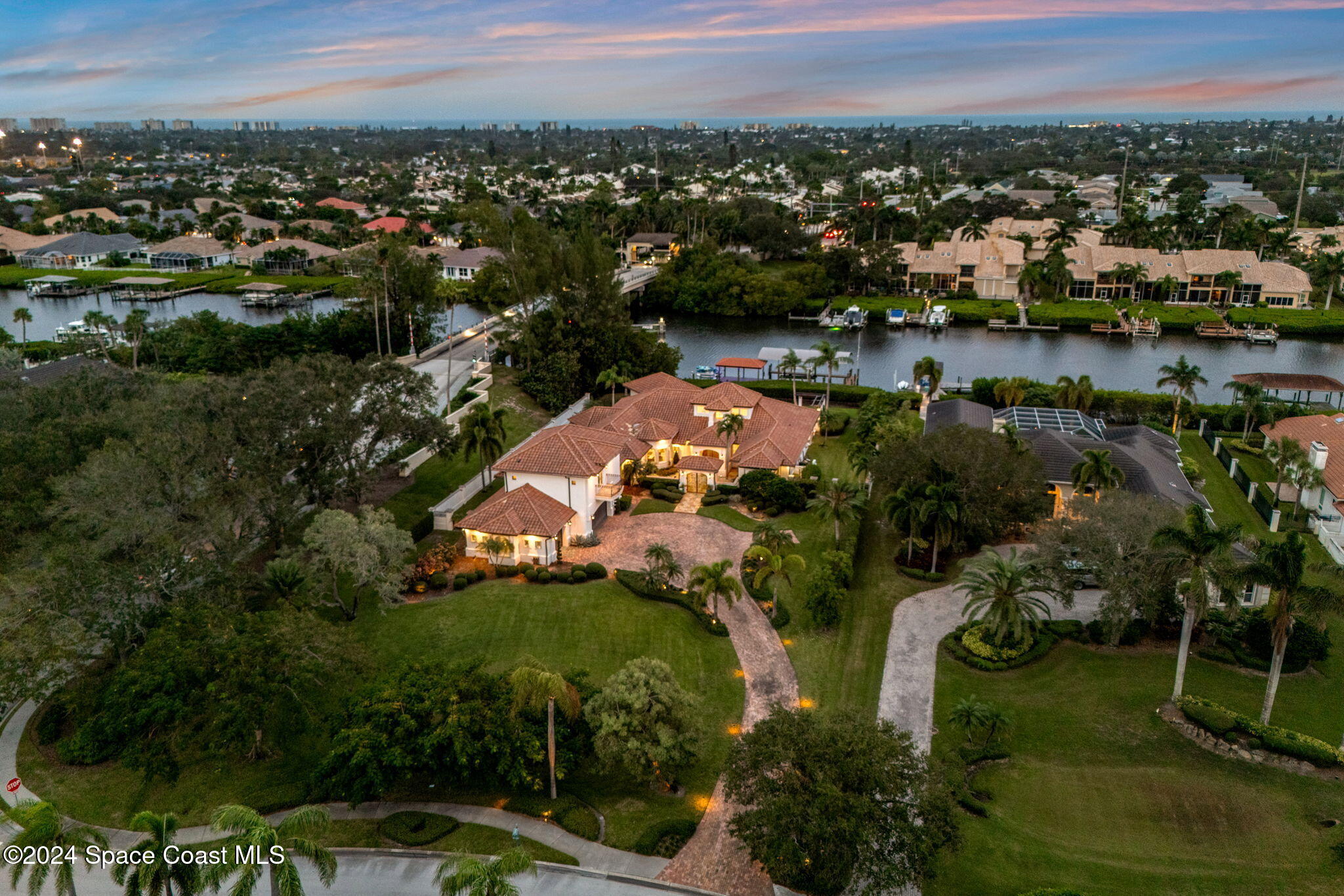 an aerial view of residential houses with outdoor space and river