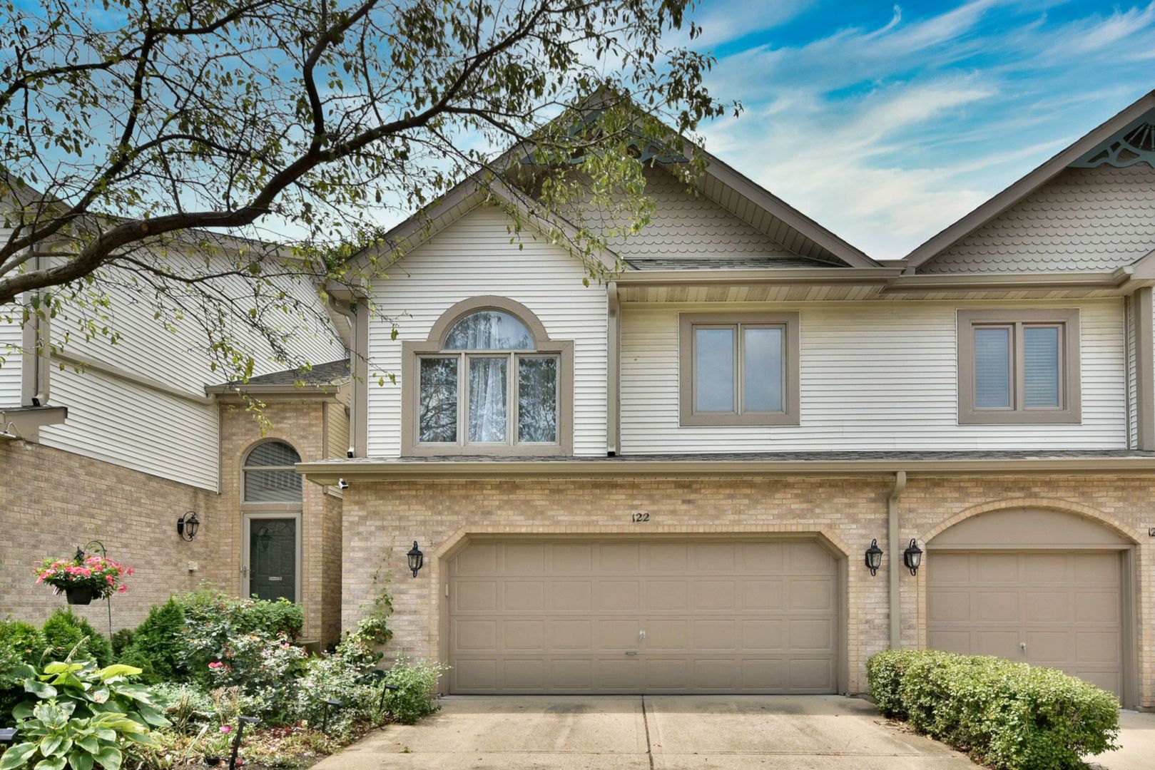 a front view of a house with garage