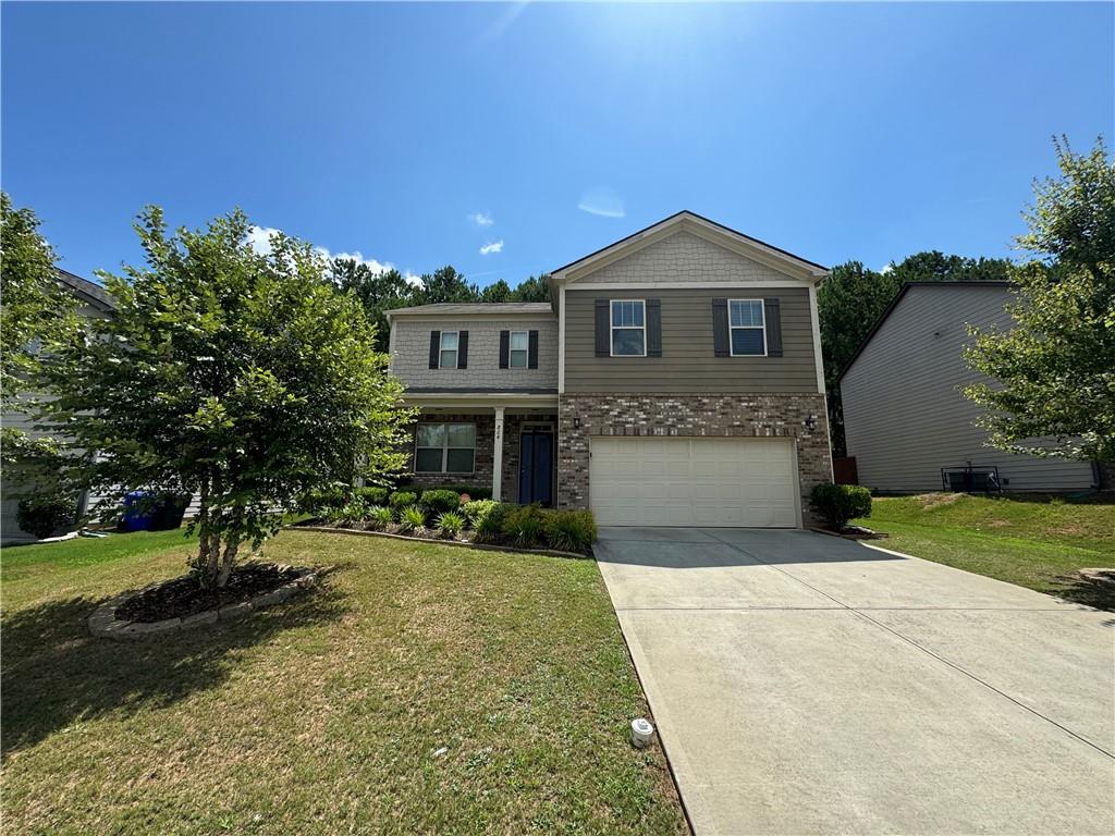 a front view of a house with a yard