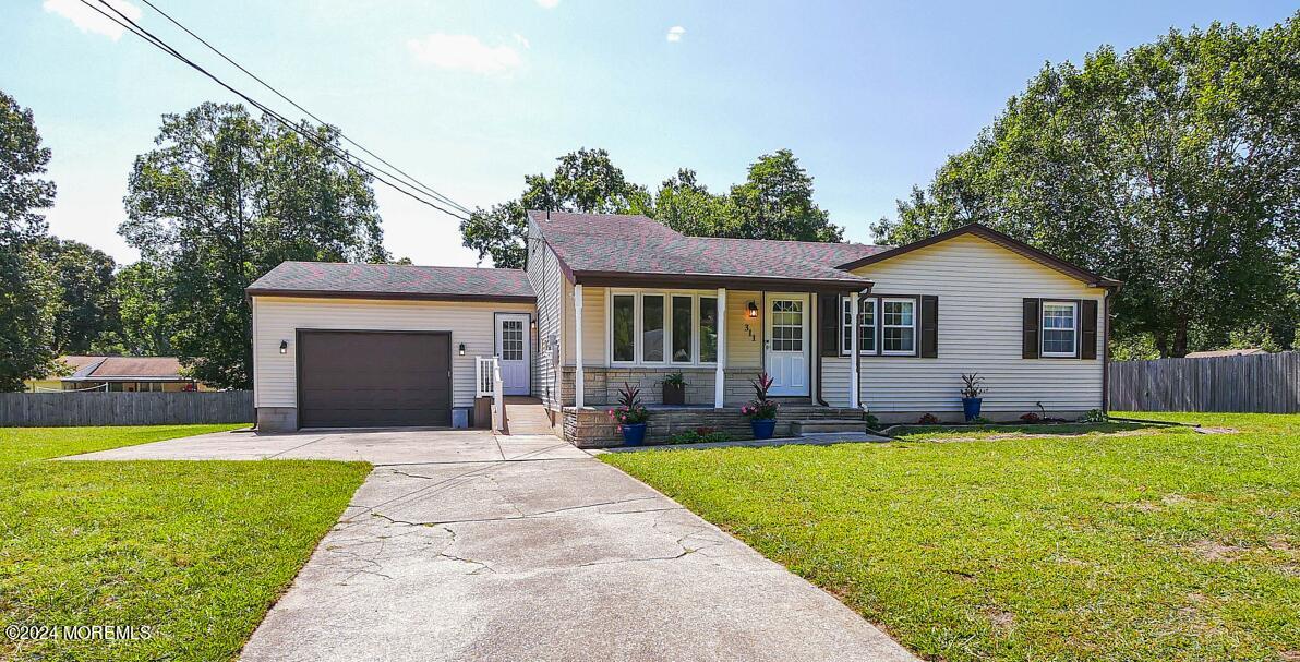 a front view of house with yard and green space