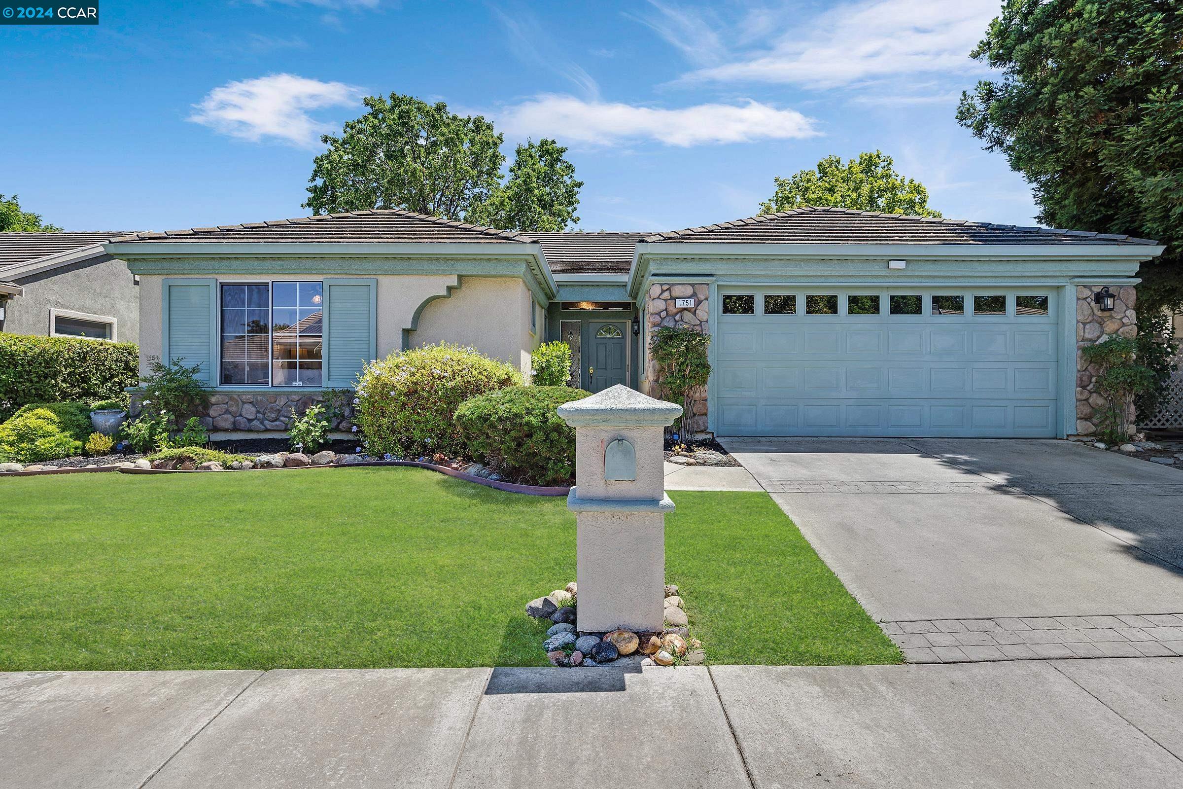 a front view of house with yard and green space