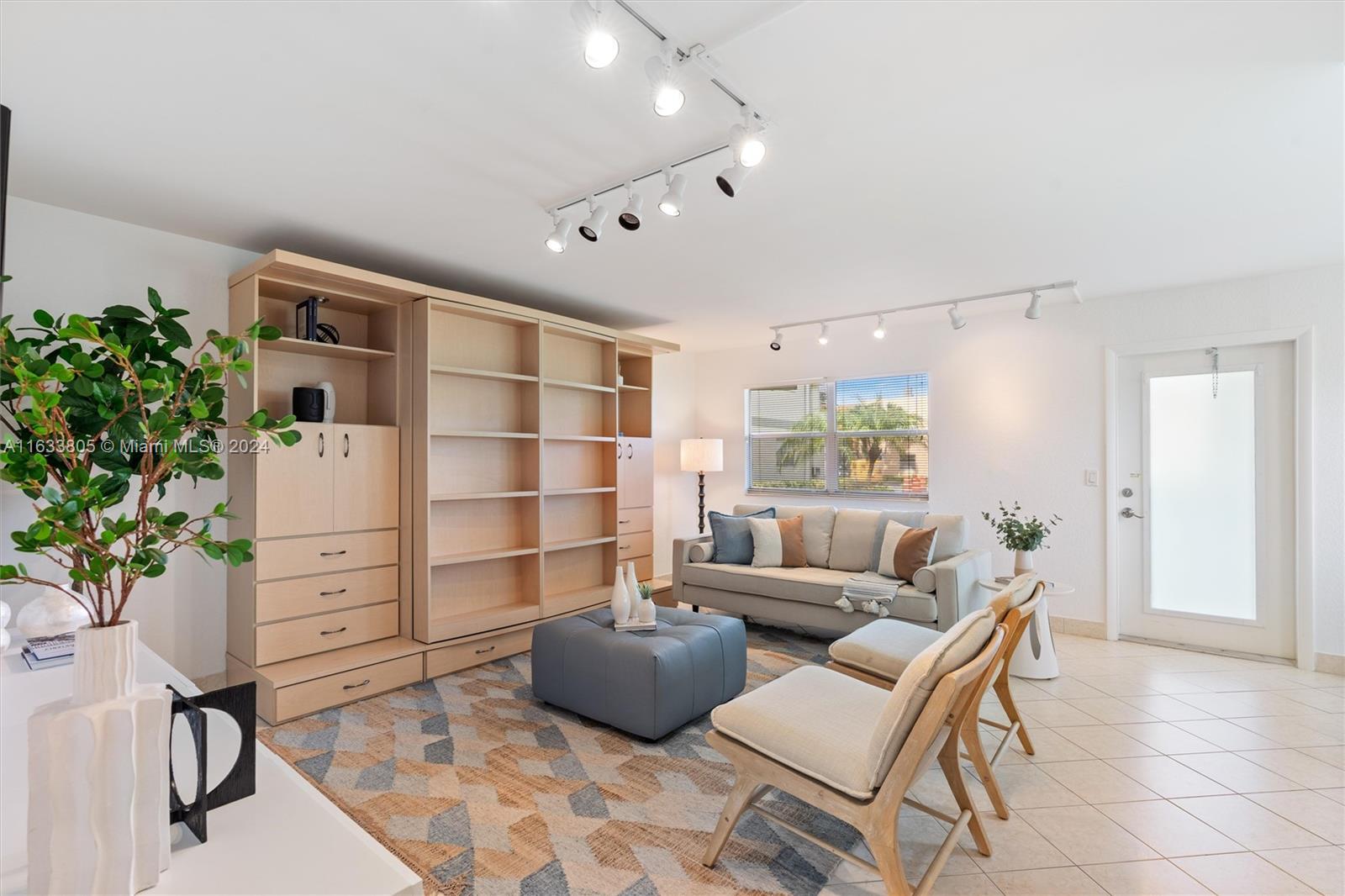 a living room with furniture and a potted plant