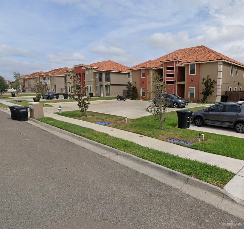 a view of multiple houses with a yard