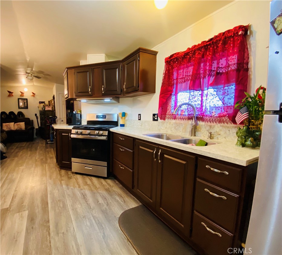 a kitchen with stainless steel appliances granite countertop a sink dishwasher stove and cabinets