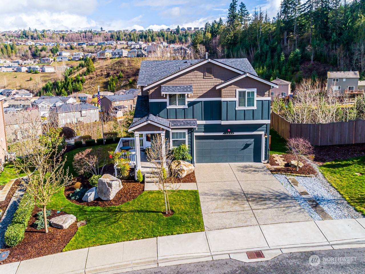 a aerial view of a house with a garden and patio