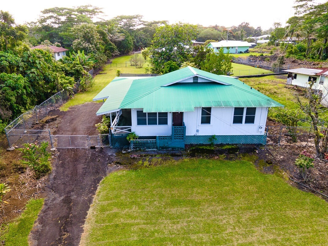 a view of a house with pool and a yard