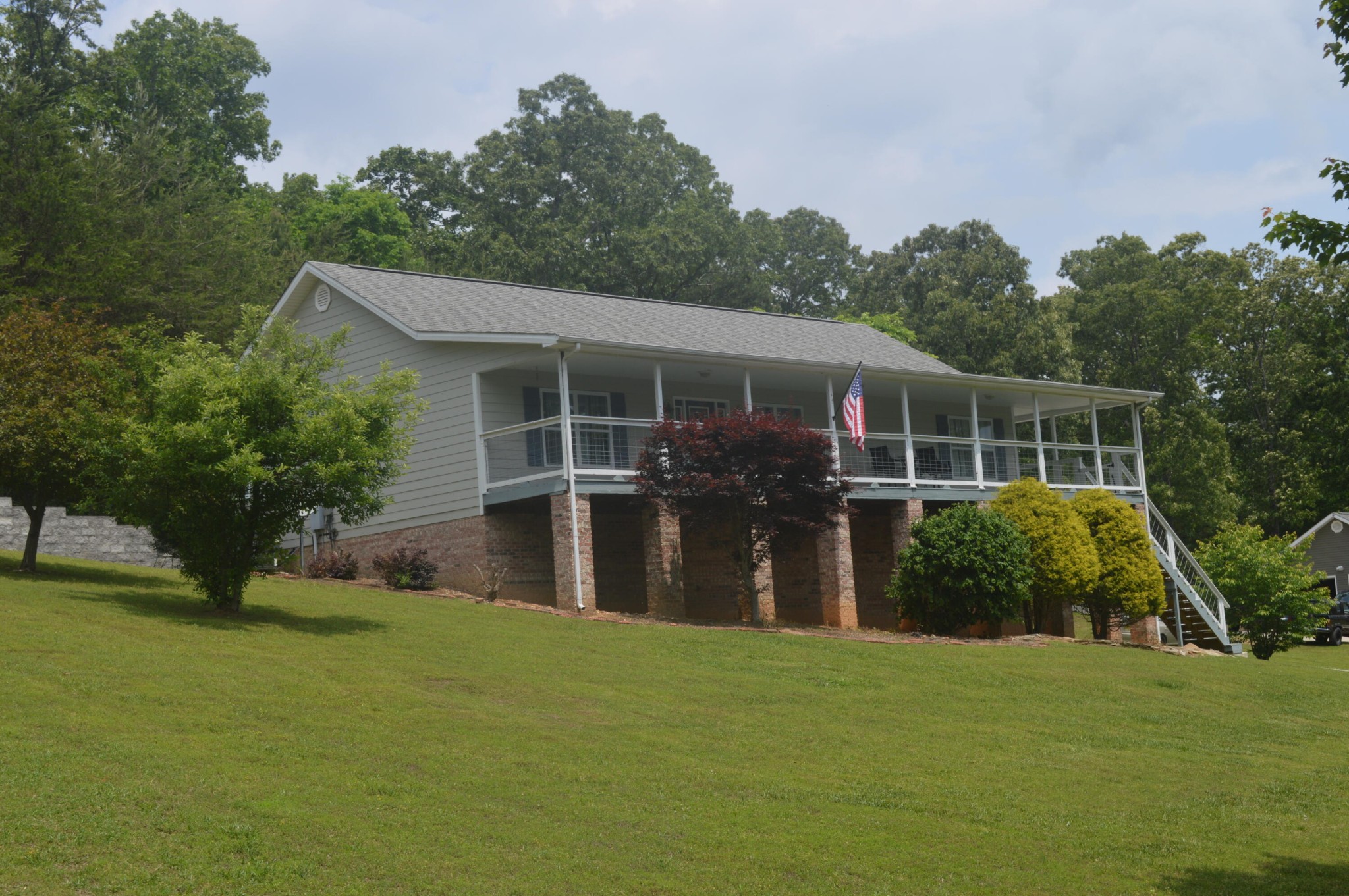 a front view of house with yard and green space