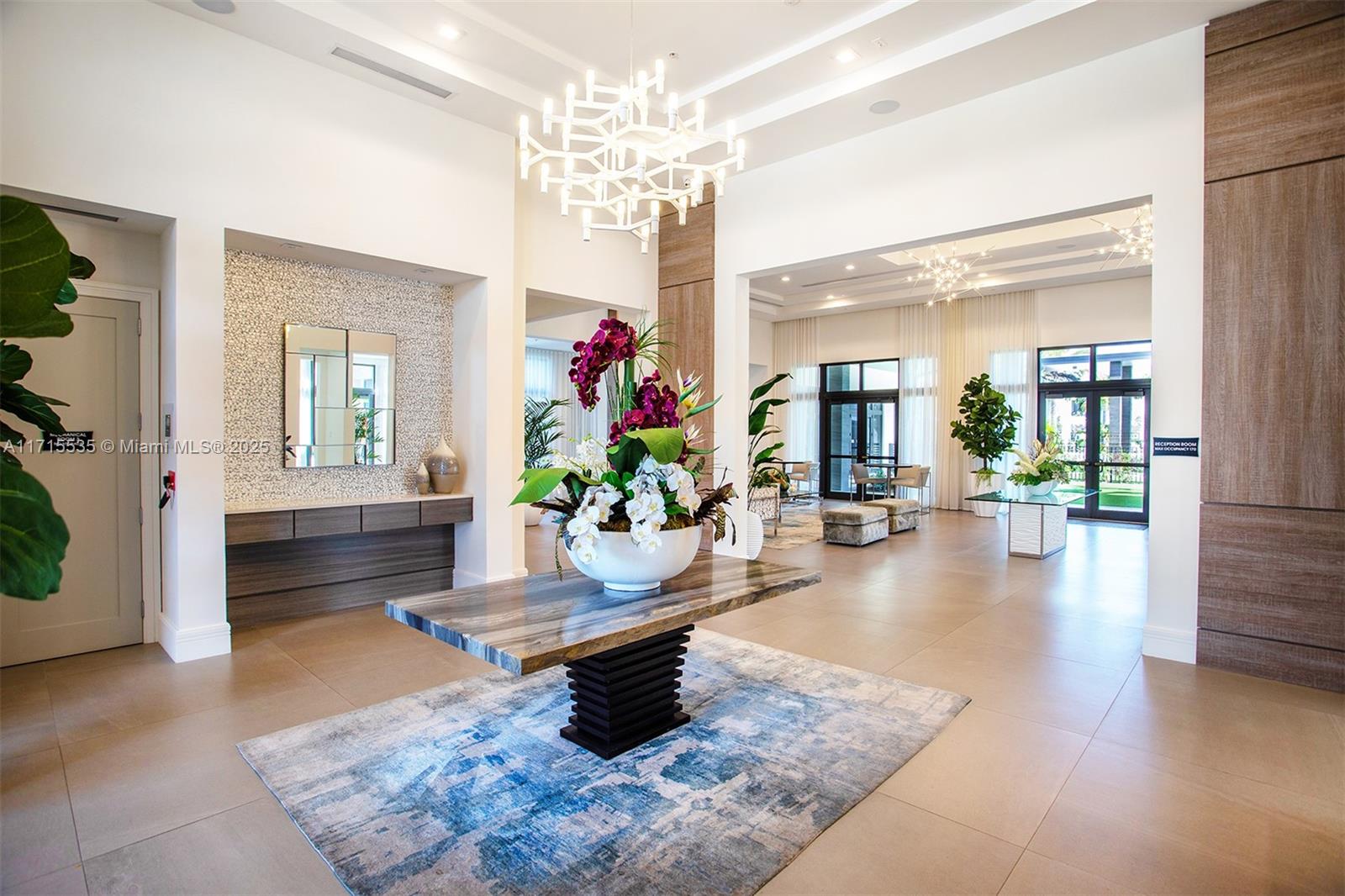 a living room with furniture and a chandelier