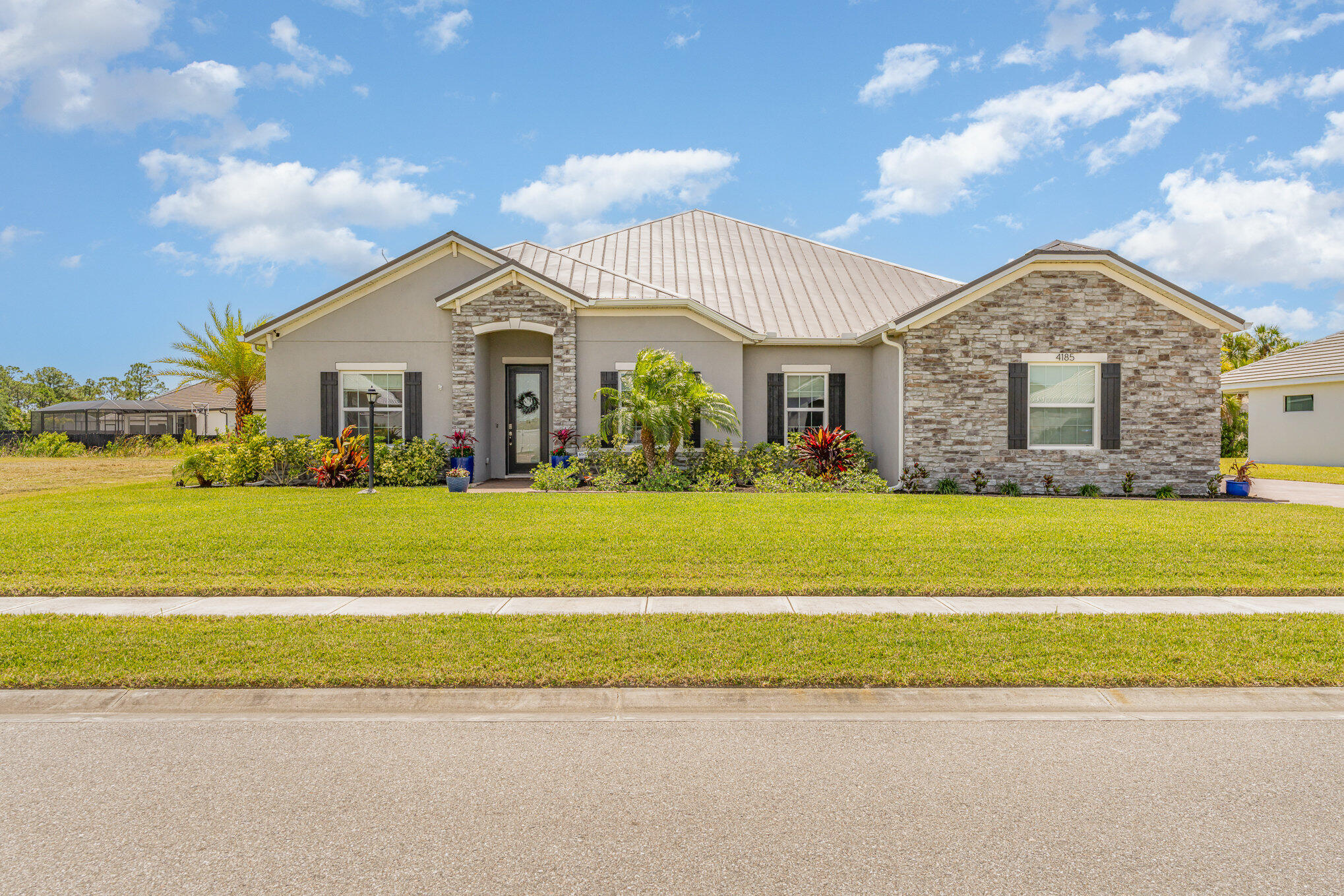 a front view of house with yard and green space