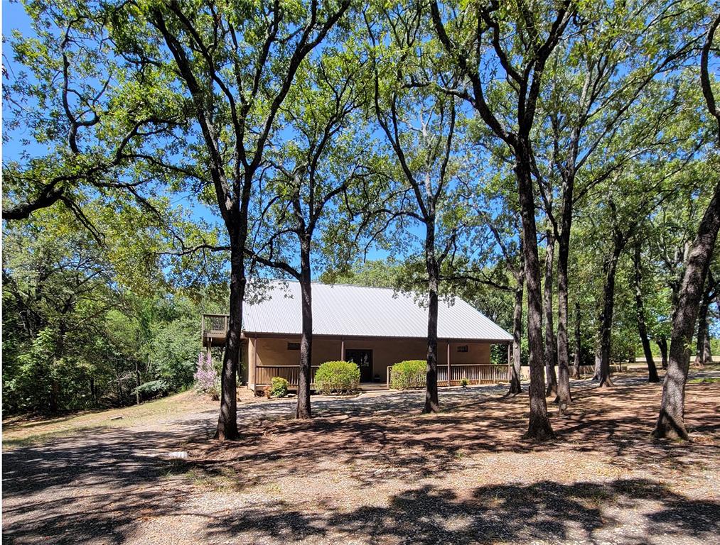 a wooden house with trees in front of it